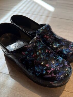 Dansko Black Floral Patent Slip-On Clogs